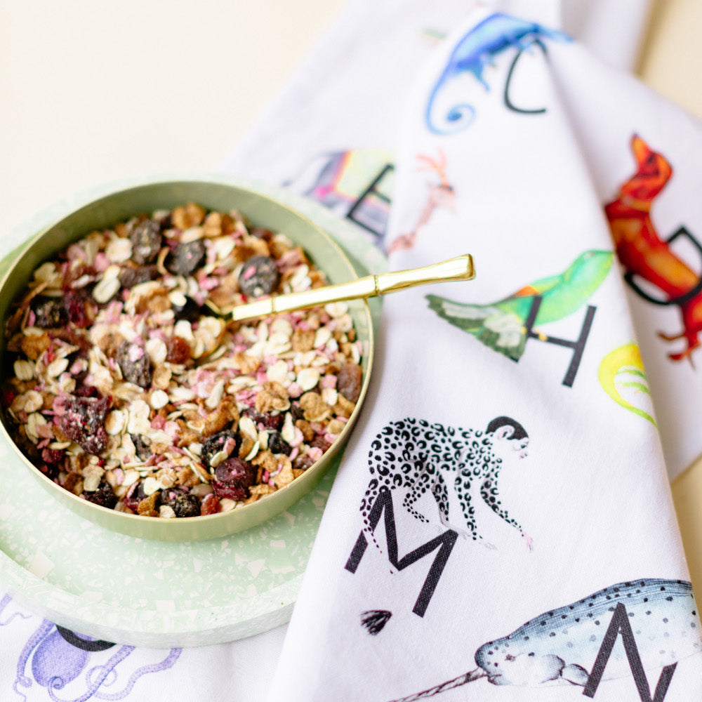 Alphabet tea towel with a bowl of granola