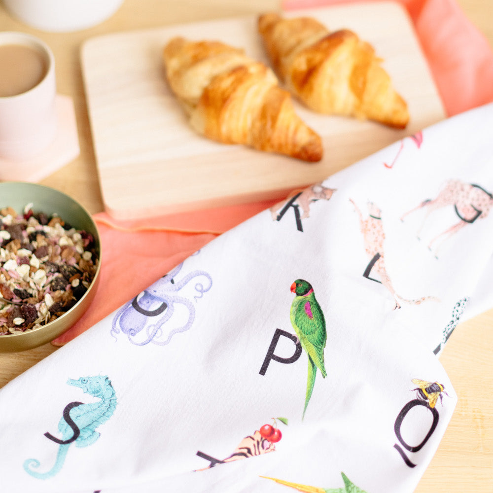 Alphabet tea towel with muesli and crossaints