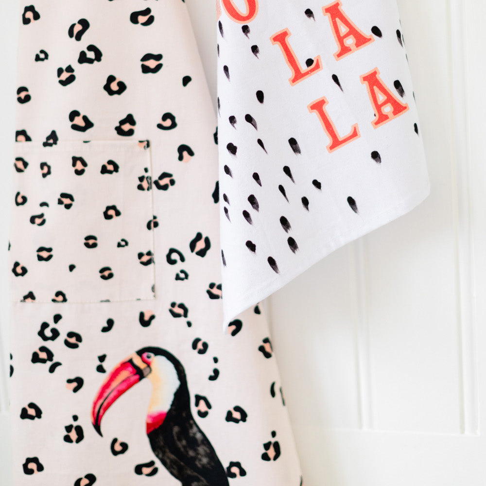 Close up of toucan apron with Ooh La La tea towel