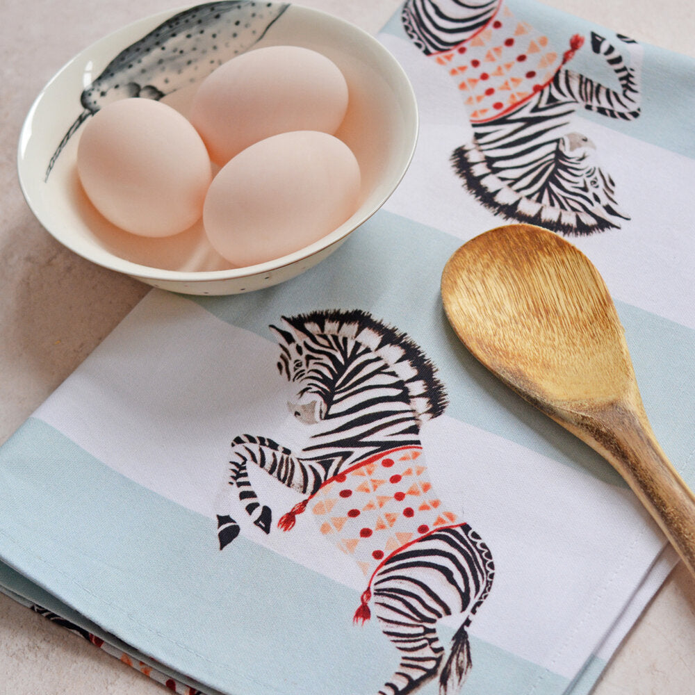 Zebra tea towel with eggs and wooden spoon